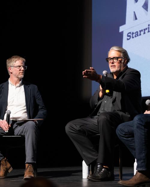 		three men on stage
	